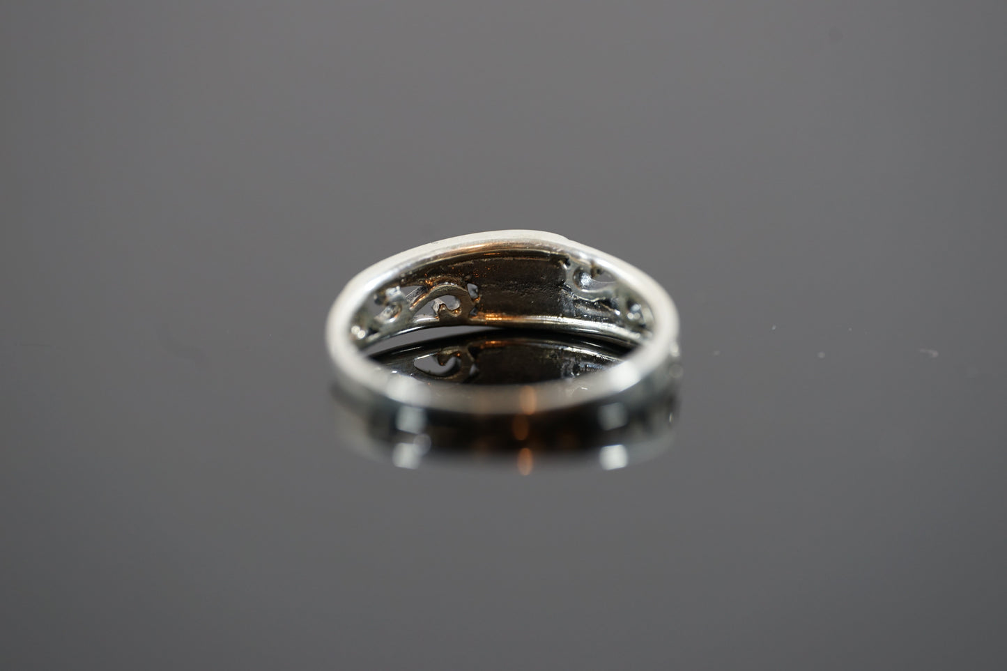 Silver Ring With Intrecate Band Design And Two Gemstones