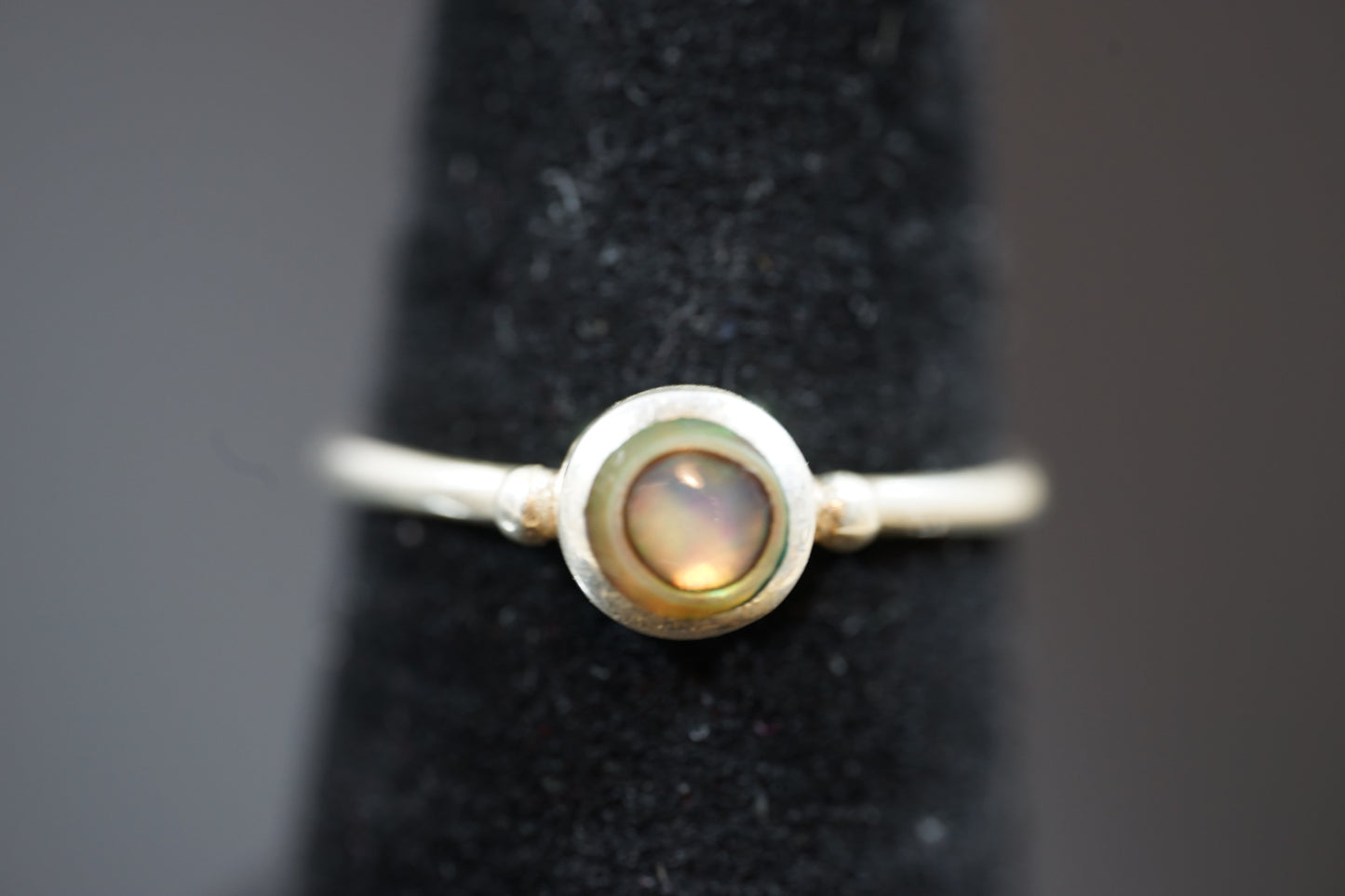 Silver Ring With Round Gemstone Between Two Silver Dots