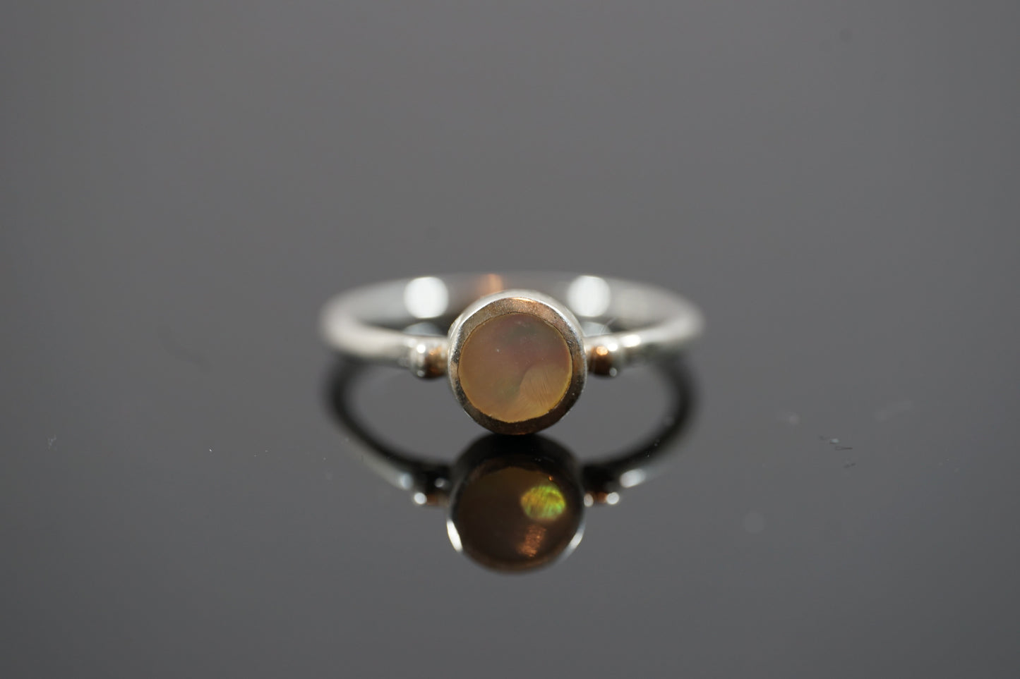 Silver Ring With Round Gemstone Between Two Silver Dots