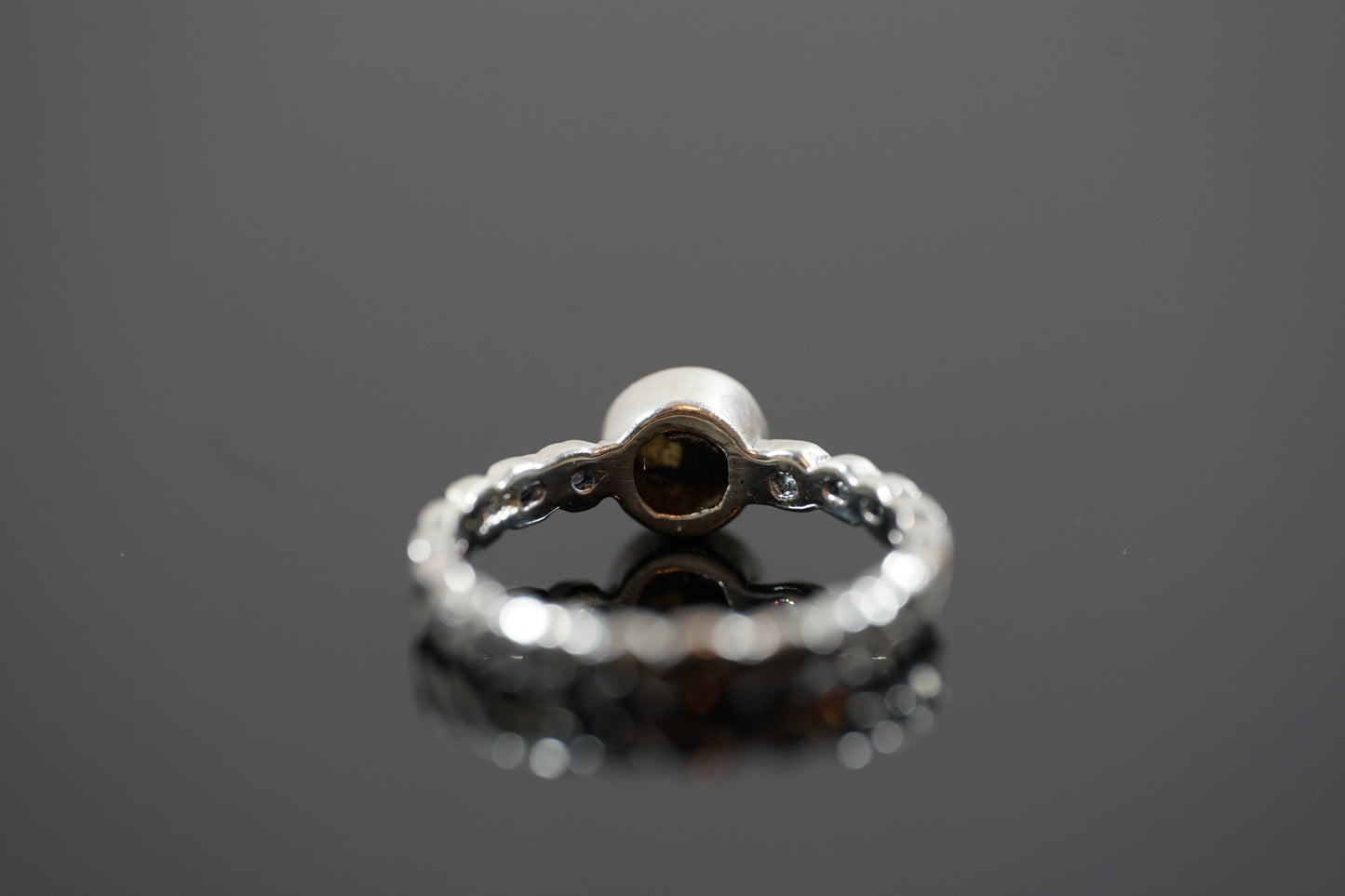 Silver Ring With Round Gemstone And Braided Band Design