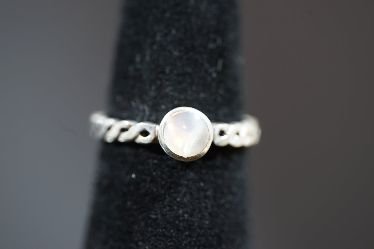 Silver Ring With Round Gemstone And Braided Band Design